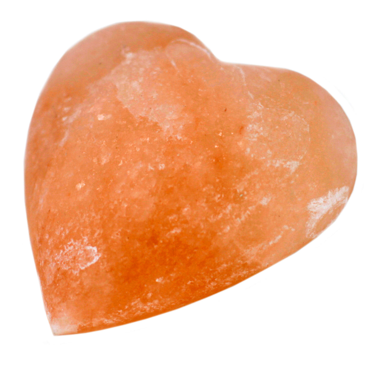 Close-up of a heart-shaped pink Himalayan salt stone with pale natural streaks