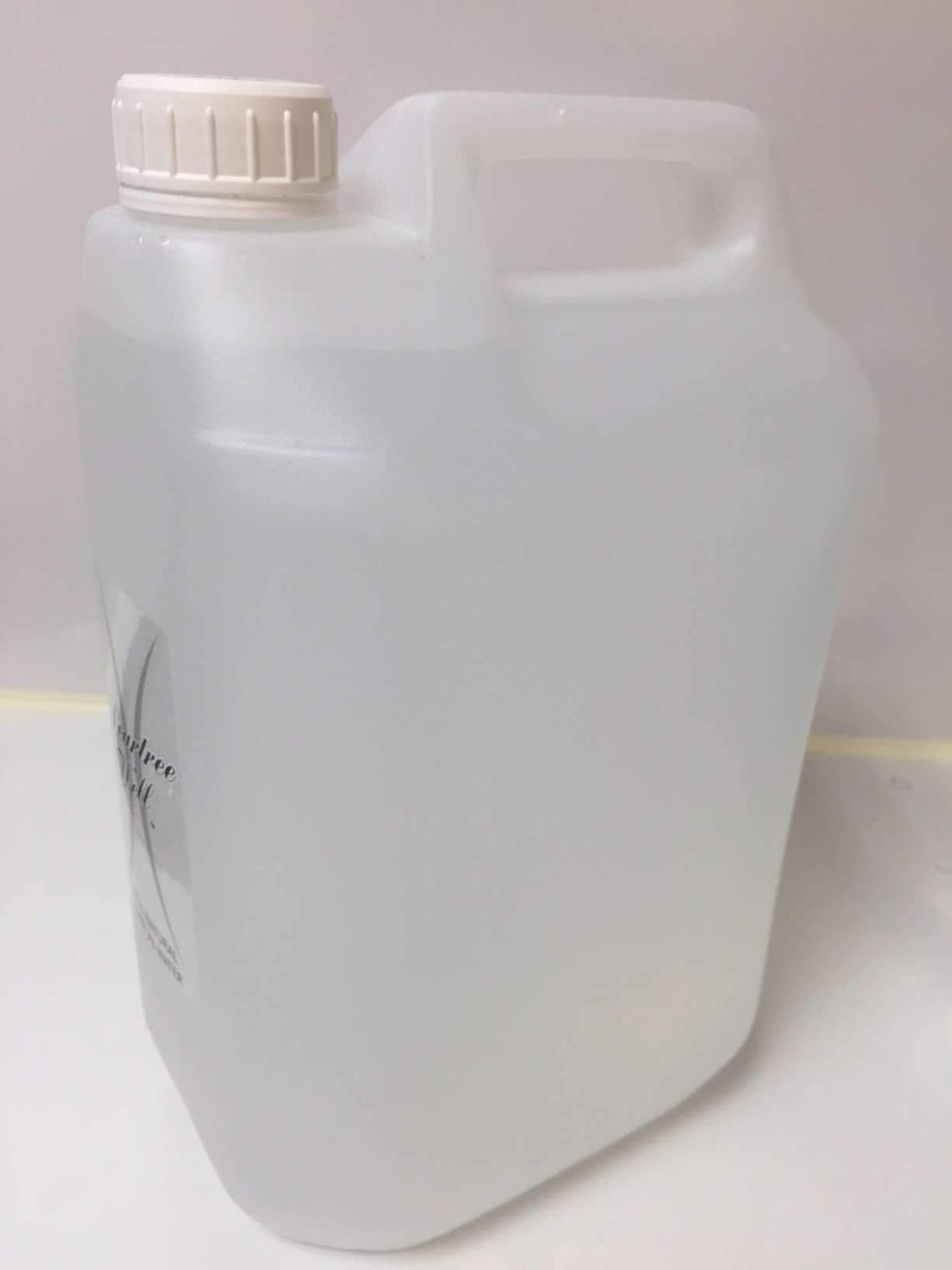 Side view of a translucent water container with a white screw cap and built-in carrying handle